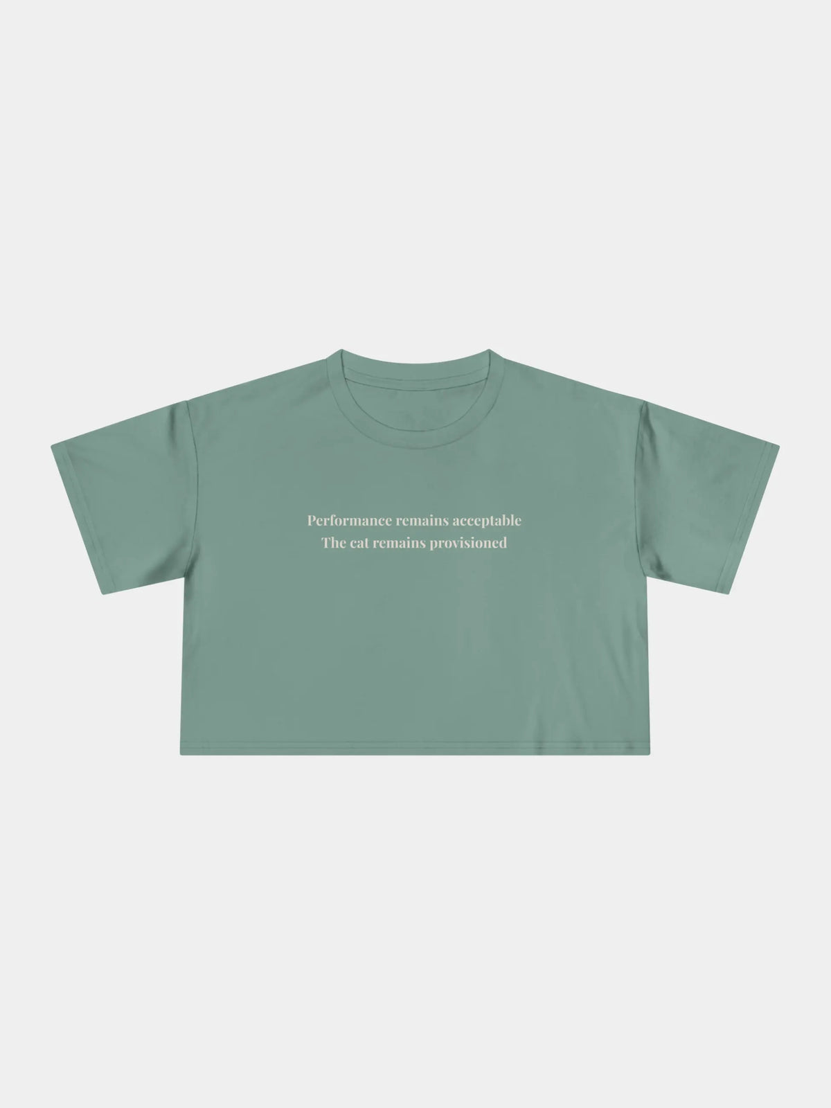 Performance Cropped Tee in Sage, printed with "Performance remains acceptable. The cat remains provisioned."
